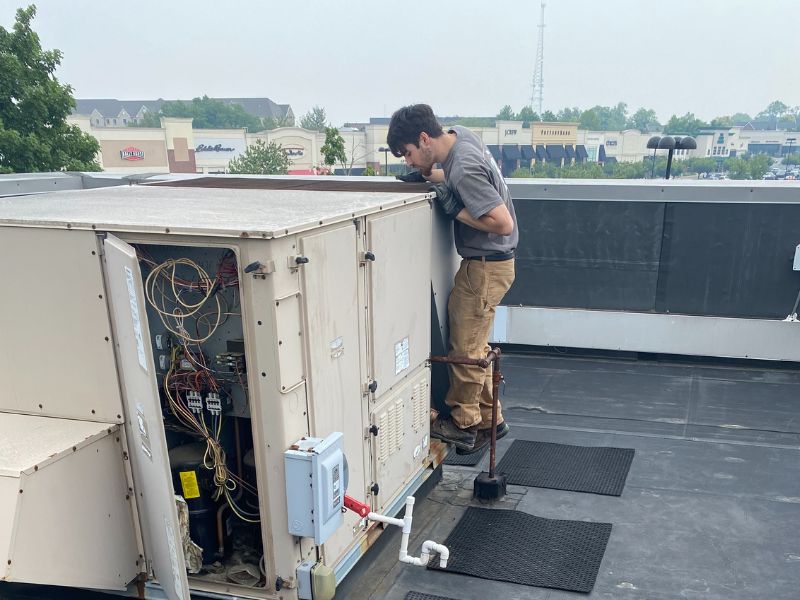 Battavio technician performing HVAC maintenance in Coatesville, PA, ensuring reliable heating and cooling services.