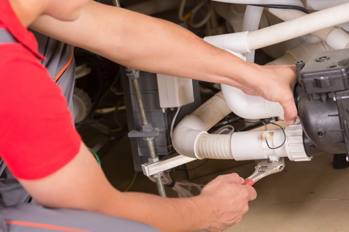 Plumber providing emergency plumbing services, repairing pipes during winter