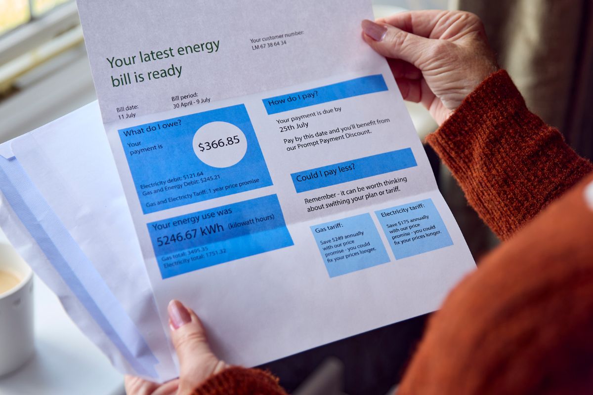 a person reviewing their energy bill, showing ways to save money on heating bills in Chester County