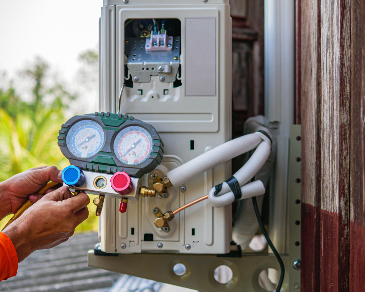 Technician performing HVAC replacement services in Chester County’s outdoor unit