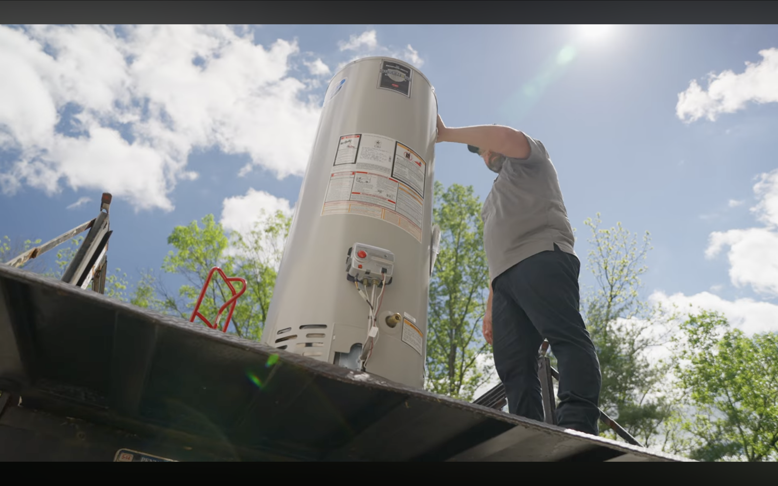 A Battavio technician delivering a water heater after an emergency water heater service visit the following day to be replaced with a brand new one.